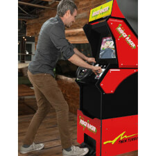People playing  A1Up Ridge Racer arcade machine.