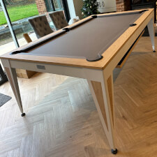 The Pureline Blade Pool Table in a white/oak finish and grey cloth.