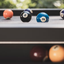 The Cornilleau Origin Outdoor Pool Table Black playing surface.