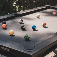 The Cornilleau Origin Outdoor Pool Table Black playing surface.