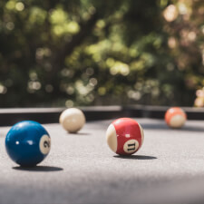 The Cornilleau Origin Outdoor Pool Table Black playing surface.