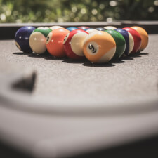 The Cornilleau Origin Outdoor Pool Table Black pocket.