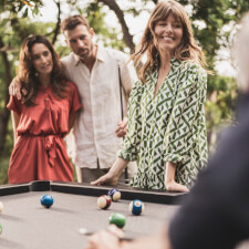 People playing Cornilleau Origin Outdoor Pool Table.