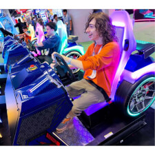 People playing the Sega Apex Rebels arcade machine.