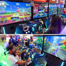 People playing the Sega Apex Rebels arcade machine.