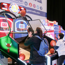 People playing the Sega NBA Game Time Basketball arcade machine.
