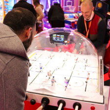 People playing SEGA Super Chexx Pro Arcade machine.