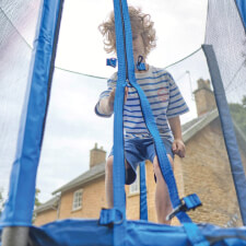 Kid playing on the Plum 6ft junior Springsafe trampoline and enclosure in blue.