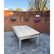 The cover fitted to an outdoor table.