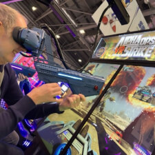 People playing Alpha Ops VR Strike Arcade Machine.