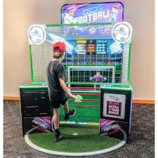 Kid Playing World Football Pro Arcade Machine.