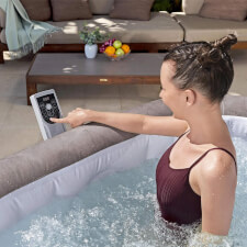 Woman using Control of Lay-Z-Spa Rome Airjet Hot Tub.