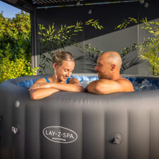 Couple enjoying the Lay-Z-Spa Santorini Hydrojet Pro Hot Tub Bubbles.