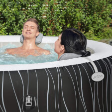 Couple using the Lay-Z-Spa Hot Tub Padded Pillow.