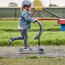 A Kid Riding The Ride-Ezy Kick & Go Ride On & Scooter.