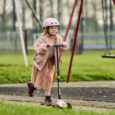 A Kid Riding the Ride-ezy Kick 3-Wheel Scooter.