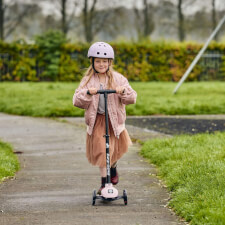 A Kid Riding the Ride-ezy Kick 3-Wheel Scooter.