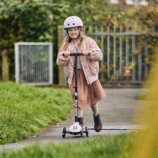 A Kid Riding the Ride-ezy Kick 3-Wheel Scooter.
