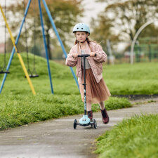A Kid Riding the Ride-ezy Kick 3-Wheel Scooter.