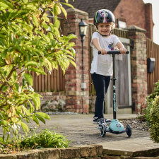 A Kid Riding the Ride-ezy Kick 3-Wheel Scooter.