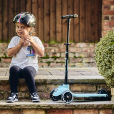 A Kid Riding the Ride-ezy Kick 3-Wheel Scooter.