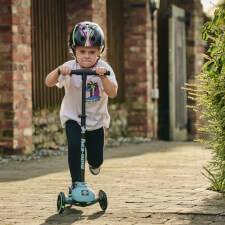 A Kid Riding the Ride-ezy Kick 3-Wheel Scooter.