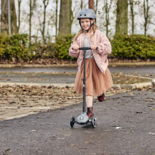 A Kid Riding the Ride-ezy Kick 3-Wheel Scooter.