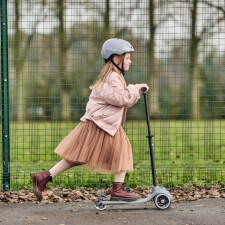 A Kid Riding the Ride-ezy Kick 3-Wheel Scooter.