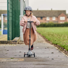 A Kid Riding the Ride-ezy Kick 3-Wheel Scooter.