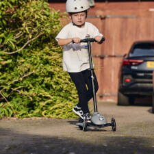 A Kid Riding the Ride-ezy Kick 3-Wheel Scooter.