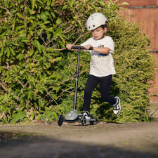 A Kid Riding the Ride-ezy Kick 3-Wheel Scooter.