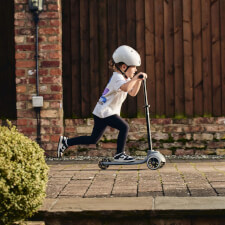A Kid Riding the Ride-ezy Kick 3-Wheel Scooter.