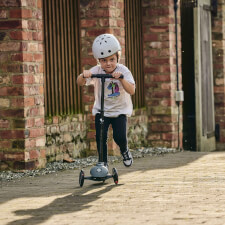 A Kid Riding the Ride-ezy Kick 3-Wheel Scooter.