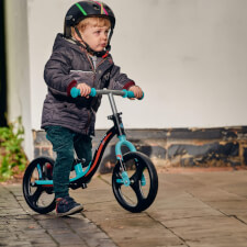 A Kid Riding the Ride-ezy Go Glo Balance Bike.