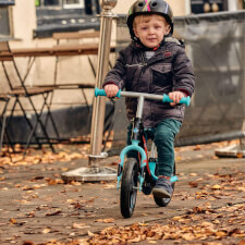 A Kid Riding the Ride-ezy Go Glo Balance Bike.