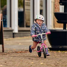 A Kid Riding the Ride-ezy Go Glo Balance Bike.