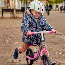 A Kid Riding the Ride-ezy Go Glo Balance Bike.