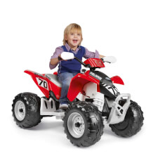 Kid enjoying Polaris Outlaw 330W Ride On Motorbike in Red.