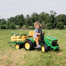 Kid Riding John Deere Ground Force Ride On Tractor.