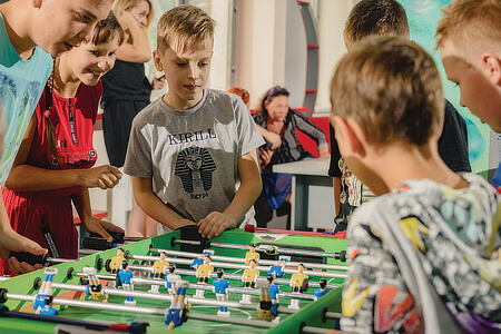 A football table being played at a youth club.